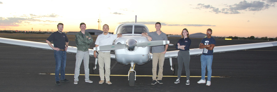 Aviation student and instructor posing in front of a CTC airplane